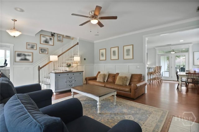 49 Tidewater Rd, Savannah, GA 31406 - living room with ceiling fan, stairway, a decorative wall, crown molding, and wainscoting