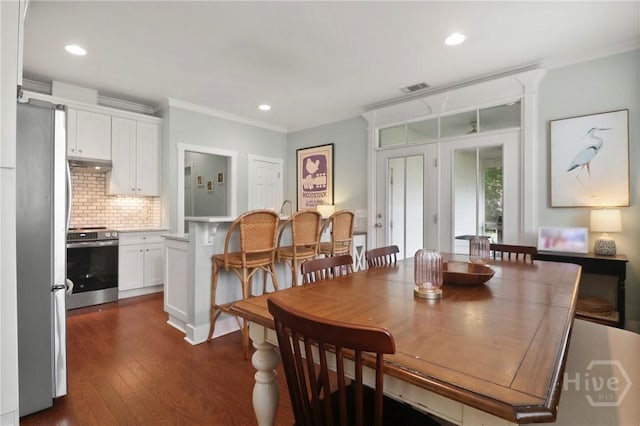49 Tidewater Rd, Savannah, GA 31406 - dining room featuring crown molding, dark wood-type flooring, and recessed lighting