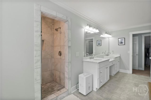 49 Tidewater Rd, Savannah, GA 31406 - bathroom with a tile shower, double vanity, crown molding, a spacious closet, and baseboards