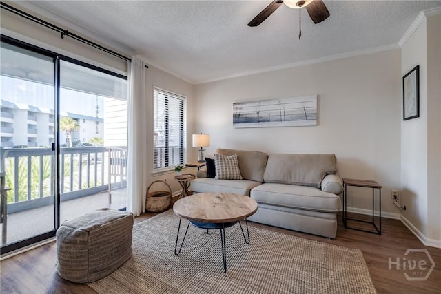 1217 Bay St Unit 105A, Tybee Island, GA 31328 - living room with crown molding, a textured ceiling, wood finished floors, and a ceiling fan