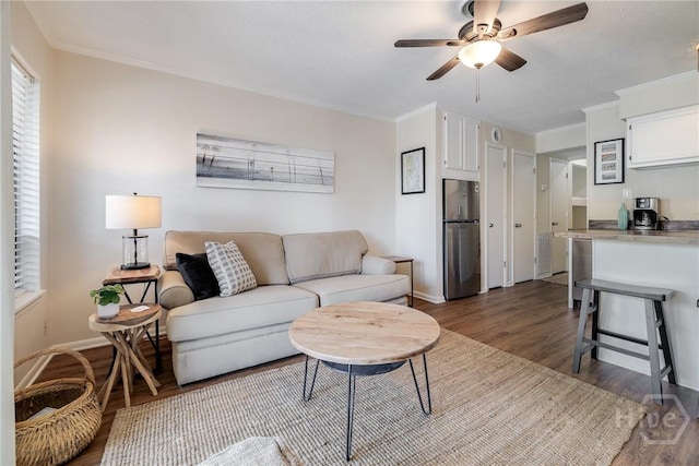 1217 Bay St Unit 105A, Tybee Island, GA 31328 - living area featuring dark wood finished floors, ceiling fan, and crown molding