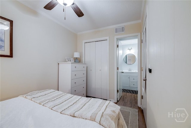 1217 Bay St Unit 105A, Tybee Island, GA 31328 - bedroom featuring wood finished floors, crown molding, a closet, and a ceiling fan
