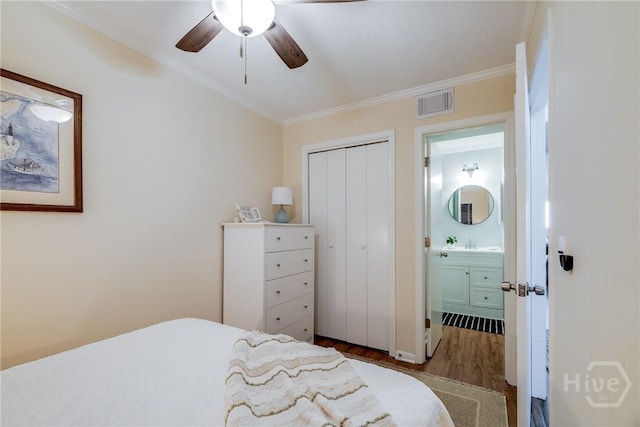1217 Bay St Unit 105A, Tybee Island, GA 31328 - bedroom with wood finished floors, ornamental molding, a closet, and ceiling fan