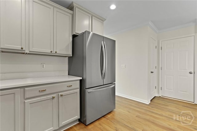 3 Chandler Bluff Dr, Savannah, GA 31407 - kitchen featuring freestanding refrigerator, light countertops, ornamental molding, light wood-style floors, and recessed lighting