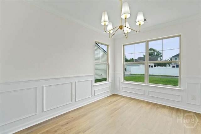 3 Chandler Bluff Dr, Savannah, GA 31407 - unfurnished dining area featuring a chandelier, crown molding, wainscoting, a decorative wall, and light wood-type flooring