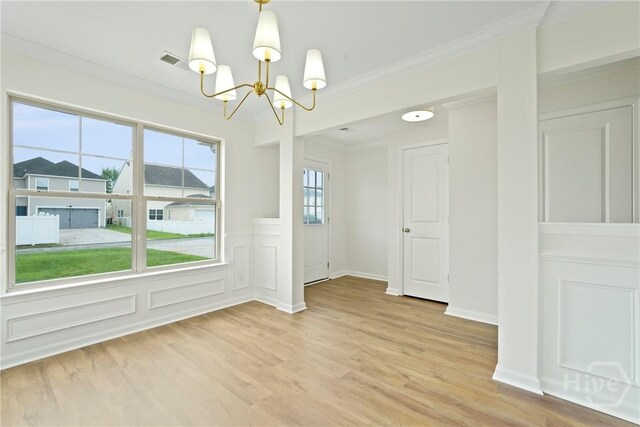 3 Chandler Bluff Dr, Savannah, GA 31407 - spare room featuring a chandelier, light wood-style floors, and crown molding