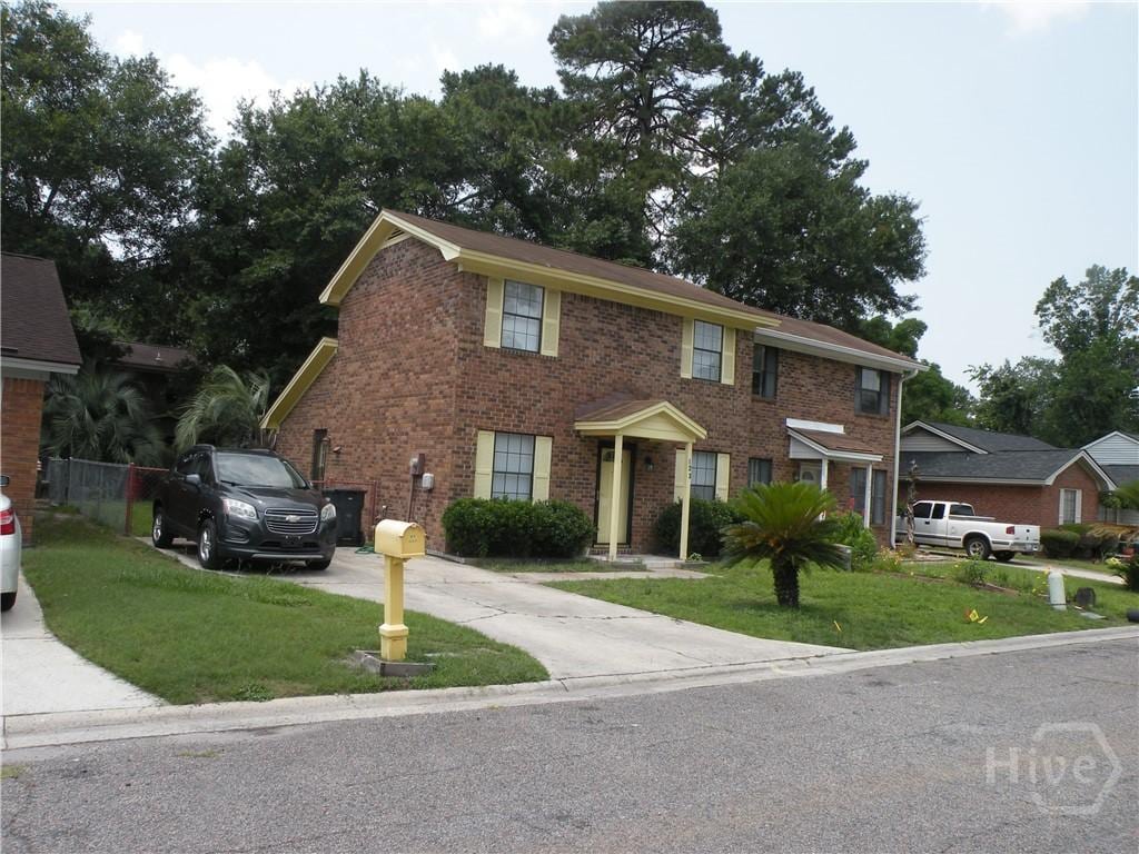 123 Hunt Club Ct, Savannah, GA 31406 - view of front of property featuring driveway, a front lawn, and brick siding
