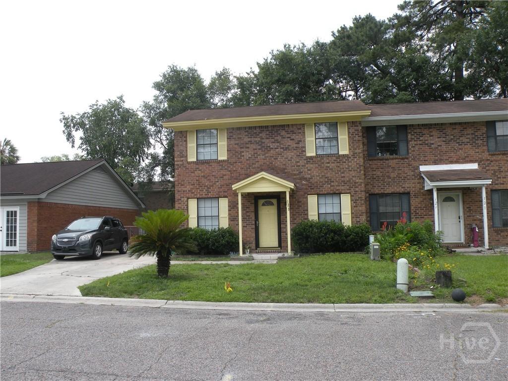 123 Hunt Club Ct, Savannah, GA 31406 - view of front of property with brick siding, a front lawn, and concrete driveway