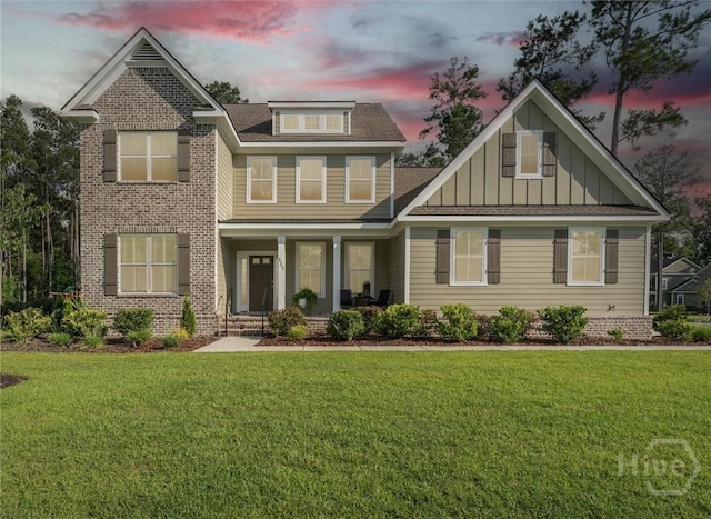 117 Oakcrest Dr W, Savannah, GA 31405 - craftsman-style house featuring covered porch, board and batten siding, a lawn, and brick siding