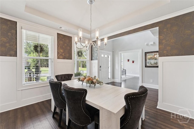 117 Oakcrest Dr W, Savannah, GA 31405 - dining room with a wainscoted wall, a chandelier, a raised ceiling, dark wood-style floors, and wallpapered walls