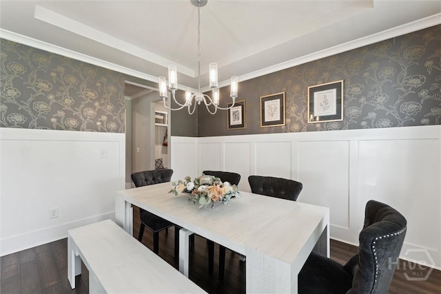117 Oakcrest Dr W, Savannah, GA 31405 - dining area featuring a chandelier, dark wood-style floors, a wainscoted wall, a tray ceiling, and ornamental molding