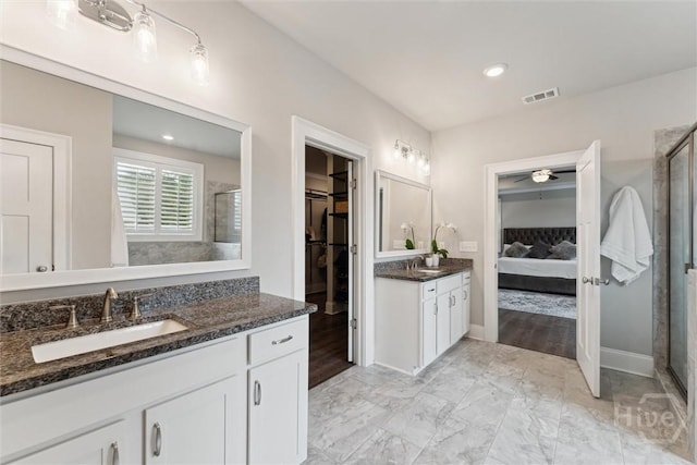 117 Oakcrest Dr W, Savannah, GA 31405 - ensuite bathroom featuring a stall shower, two vanities, a ceiling fan, a walk in closet, and marble finish floors