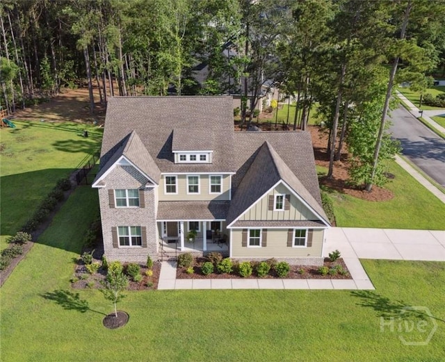 117 Oakcrest Dr W, Savannah, GA 31405 - view of front of property with board and batten siding, a front yard, a shingled roof, and a porch