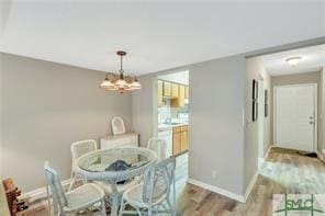1000 New Sea Island Rd Unit 15, Saint Simons Island, GA 31522 - dining room featuring a chandelier and wood finished floors