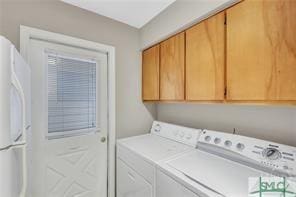 1000 New Sea Island Rd Unit 15, Saint Simons Island, GA 31522 - washroom featuring separate washer and dryer and cabinet space