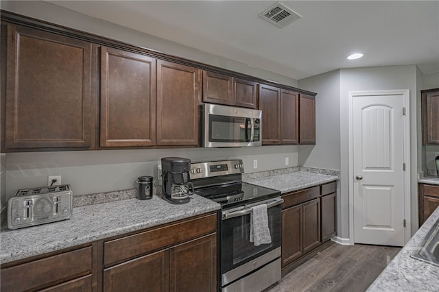 452 Keller Rd, Rincon, GA 31326 - kitchen featuring stainless steel appliances, dark wood-type flooring, dark brown cabinets, and recessed lighting