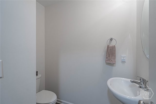 452 Keller Rd, Rincon, GA 31326 - half bathroom featuring a sink and toilet