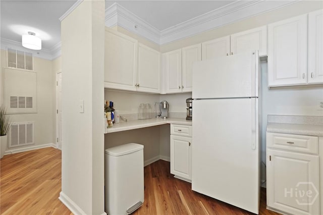 2034 Whitemarsh Way, Savannah, GA 31410 - kitchen featuring freestanding refrigerator, ornamental molding, white cabinets, and wood finished floors