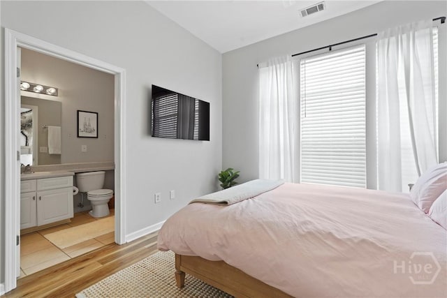 2034 Whitemarsh Way, Savannah, GA 31410 - bedroom with light wood-type flooring and ensuite bathroom