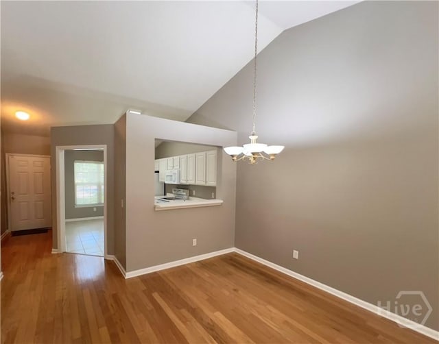 122 River Pointe Dr, Savannah, GA 31410 - spare room featuring a chandelier, lofted ceiling, and wood finished floors