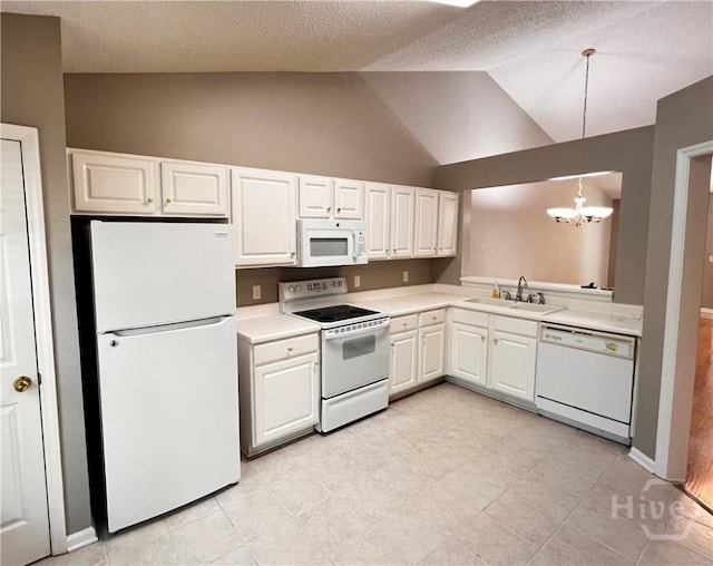 122 River Pointe Dr, Savannah, GA 31410 - kitchen featuring white appliances, a chandelier, light countertops, white cabinetry, and hanging light fixtures