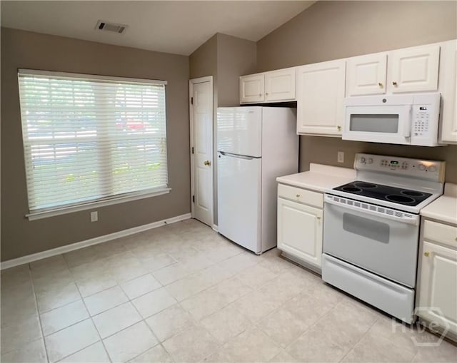 122 River Pointe Dr, Savannah, GA 31410 - kitchen featuring white appliances, white cabinetry, vaulted ceiling, and light countertops