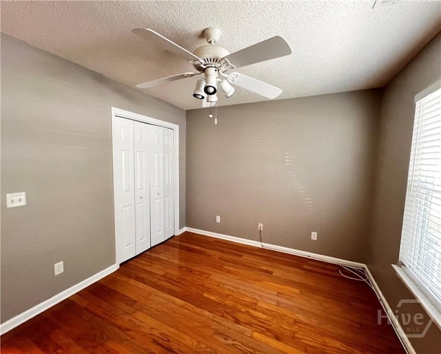122 River Pointe Dr, Savannah, GA 31410 - unfurnished bedroom featuring wood finished floors, a closet, a textured ceiling, and ceiling fan