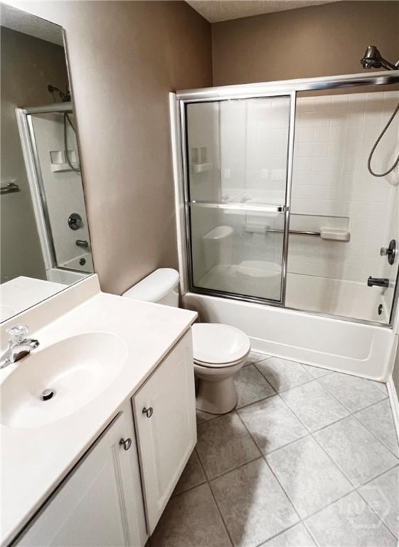 122 River Pointe Dr, Savannah, GA 31410 - bathroom with vanity, shower / bath combination with glass door, tile patterned flooring, and a textured ceiling