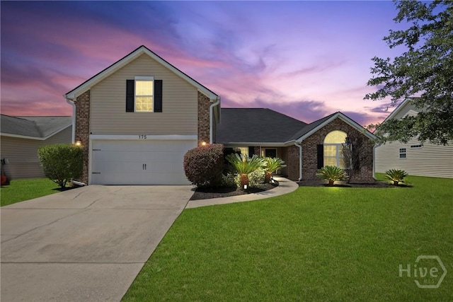 175 Willow Point Cir, Savannah, GA 31407 - traditional-style house with driveway, an attached garage, a yard, and brick siding