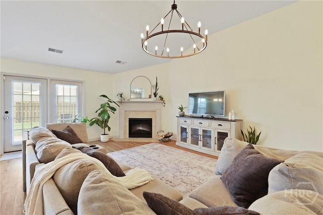 175 Willow Point Cir, Savannah, GA 31407 - living room with a chandelier, wood finished floors, and a fireplace