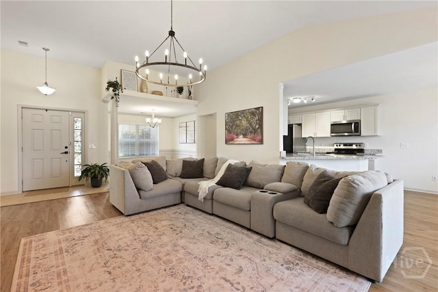 175 Willow Point Cir, Savannah, GA 31407 - living room featuring a chandelier and light wood-style flooring