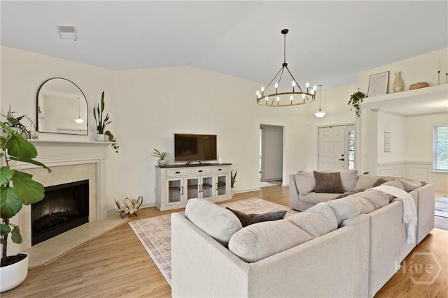 175 Willow Point Cir, Savannah, GA 31407 - living room with a chandelier, wood finished floors, vaulted ceiling, and a premium fireplace