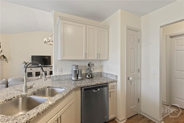 175 Willow Point Cir, Savannah, GA 31407 - kitchen with dishwasher, light wood-style flooring, a chandelier, open floor plan, and light stone countertops