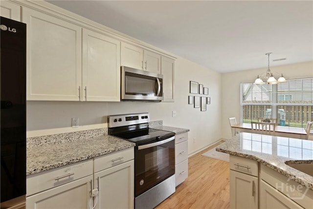 175 Willow Point Cir, Savannah, GA 31407 - kitchen with stainless steel appliances, a chandelier, light wood-type flooring, light stone counters, and hanging light fixtures