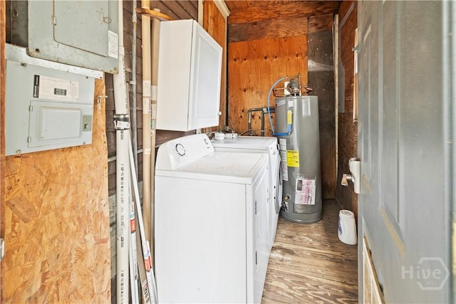 1212 Price St, Savannah, GA 31401 - laundry room featuring water heater, light wood finished floors, washer and clothes dryer, cabinet space, and electric panel