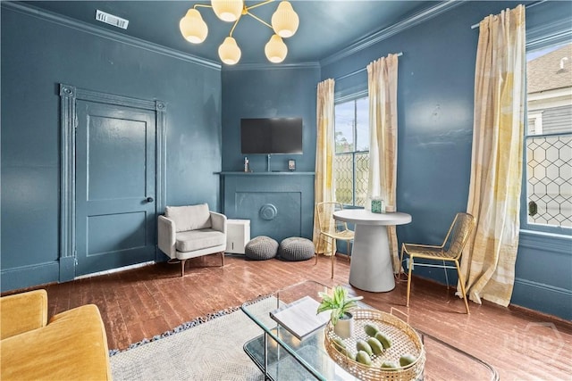 1212 Price St, Savannah, GA 31401 - sitting room featuring wood finished floors, ornamental molding, and a chandelier