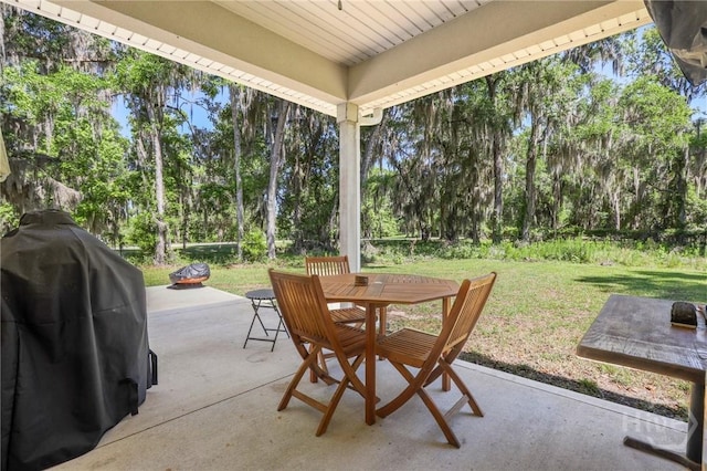 1003 Dolphin Ct, Townsend, GA 31331 - view of patio / terrace featuring outdoor dining space, a grill, an outdoor fire pit, and view of wooded area