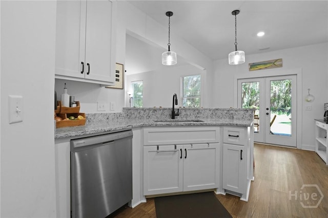 1003 Dolphin Ct, Townsend, GA 31331 - kitchen featuring stainless steel dishwasher, a peninsula, white cabinets, dark wood-style flooring, and light stone countertops