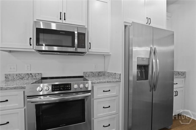 1003 Dolphin Ct, Townsend, GA 31331 - kitchen with stainless steel appliances, white cabinetry, and light stone counters