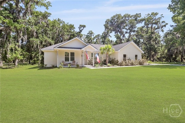 1003 Dolphin Ct, Townsend, GA 31331 - single story home featuring a front yard, stucco siding, and covered porch