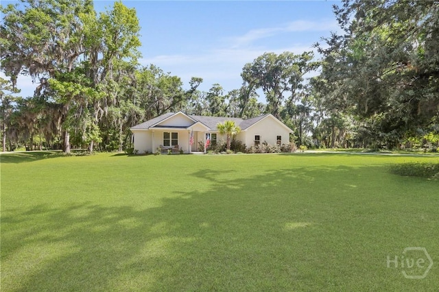 1003 Dolphin Ct, Townsend, GA 31331 - single story home featuring a front lawn and stucco siding
