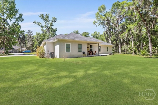 1003 Dolphin Ct, Townsend, GA 31331 - back of house with a yard and stucco siding