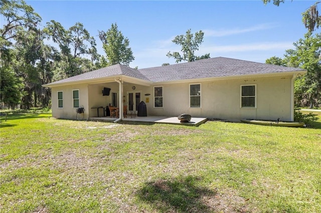1003 Dolphin Ct, Townsend, GA 31331 - rear view of property featuring stucco siding, a patio area, and a yard
