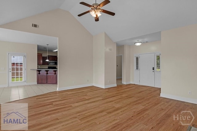 432 Cypress Creek Dr NE, Ludowici, GA 31316 - unfurnished living room with high vaulted ceiling, a ceiling fan, and light wood-style flooring
