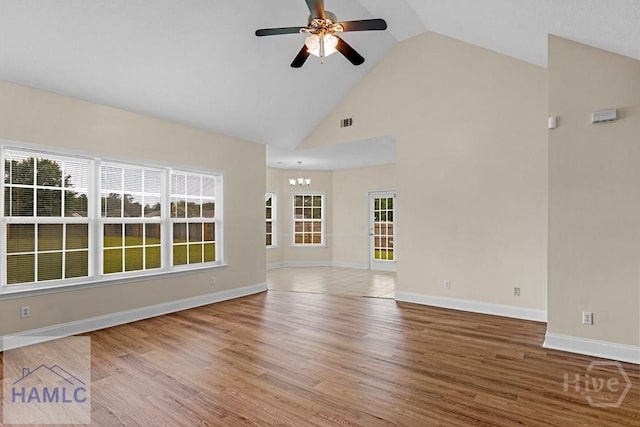 432 Cypress Creek Dr NE, Ludowici, GA 31316 - unfurnished living room featuring ceiling fan, wood finished floors, a chandelier, and high vaulted ceiling