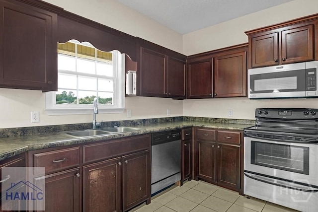 432 Cypress Creek Dr NE, Ludowici, GA 31316 - kitchen featuring stainless steel appliances, dark countertops, and light tile patterned floors