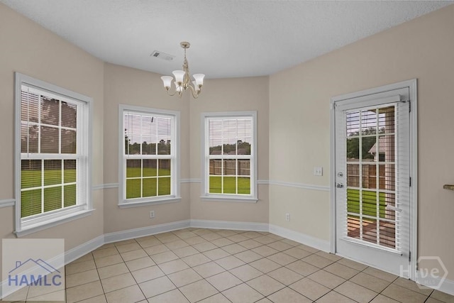 432 Cypress Creek Dr NE, Ludowici, GA 31316 - unfurnished dining area with a chandelier, healthy amount of natural light, and light tile patterned floors