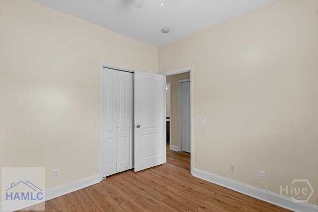 432 Cypress Creek Dr NE, Ludowici, GA 31316 - unfurnished bedroom featuring light wood-style floors, a closet, and a ceiling fan