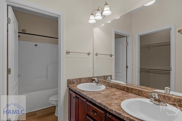 432 Cypress Creek Dr NE, Ludowici, GA 31316 - full bath with double vanity, wood finished floors, bathtub / shower combination, and a spacious closet