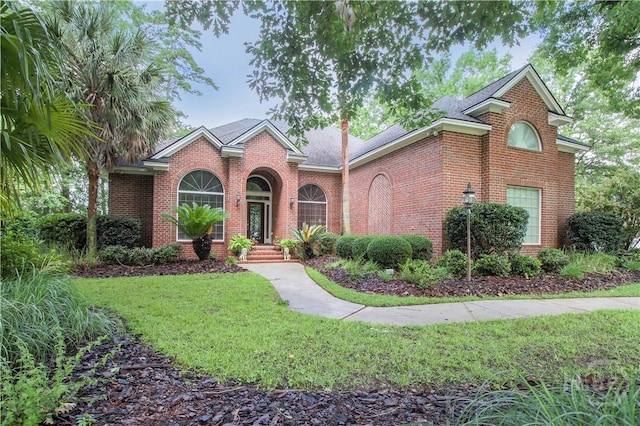 39 Grand Lake Cir, Savannah, GA 31405 - traditional-style home featuring brick siding and a front yard
